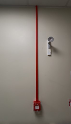 Fire alarm call point installed with cable riser